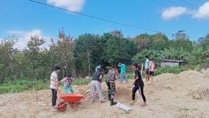 Sertu I Kadek Wirawan Turun Tangan Bersama Warga Rapikan Halaman Kantor Desa Popnam