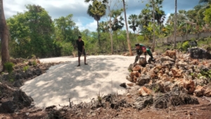 Babinsa Koramil 1627-03/Batutua Bantu Warga Angkat Batu dan Pasir untuk Pembuatan Fondasi Rumah