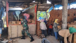 Babinsa Labuan Tereng Ringankan Beban Warga Angkut Batu Bata